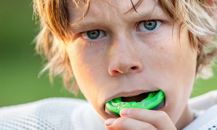 Boy putting in his mouth guard