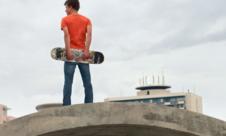 teen-with-skateboard-750×450
